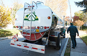 Service tech in front of oil truck